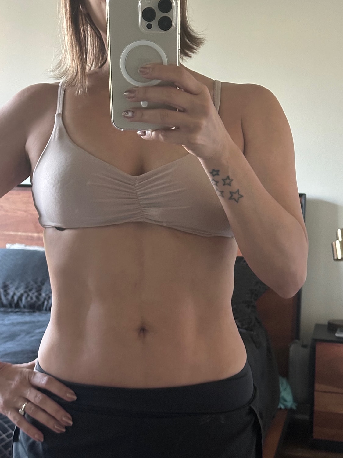 Selfie showing midsection and tattoo details.
