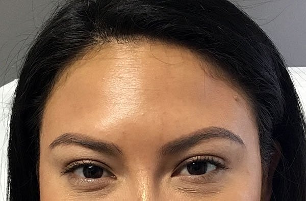 Close-up of a woman's eyes and forehead.