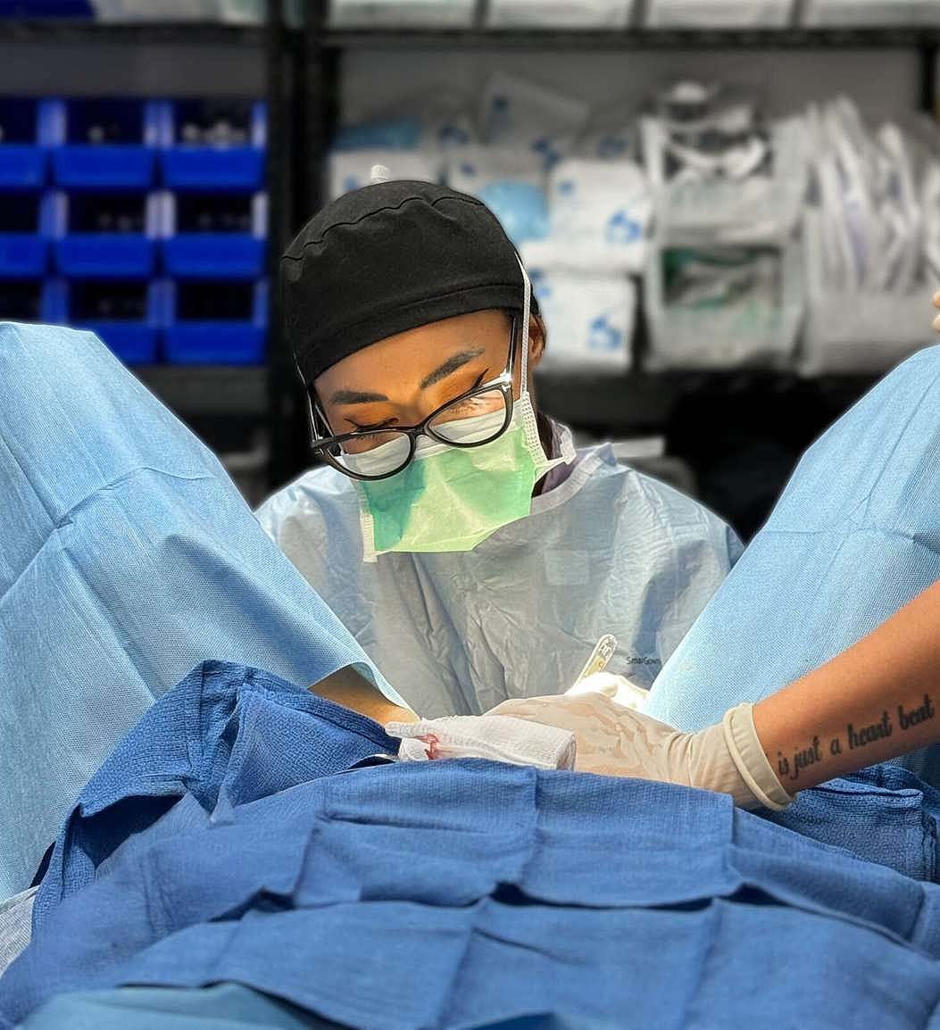 Surgeon focused on procedure in operating room.