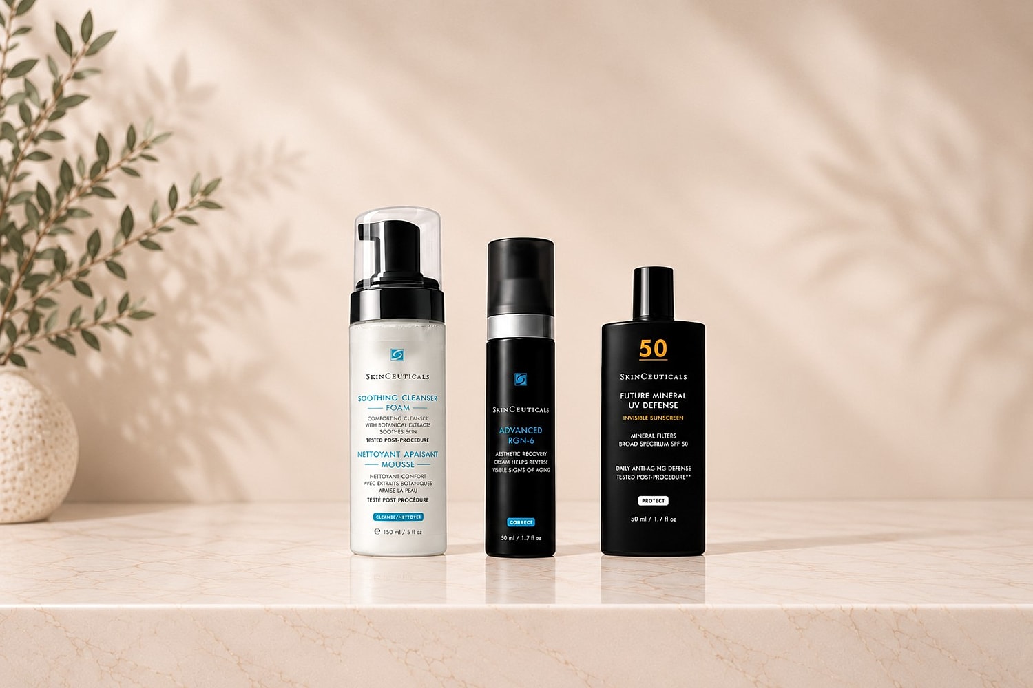 Skincare products on a marble countertop with greenery.