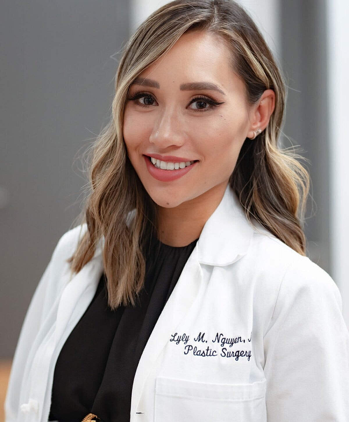 Female doctor smiling in a medical coat.