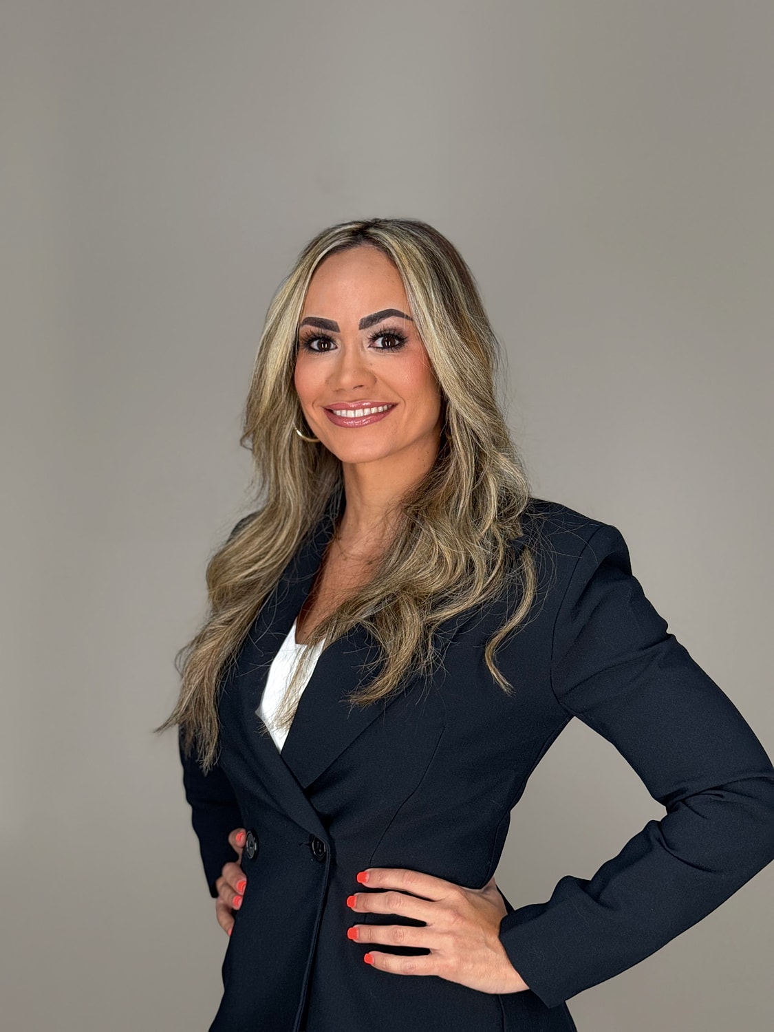 Professional woman smiling in business attire.