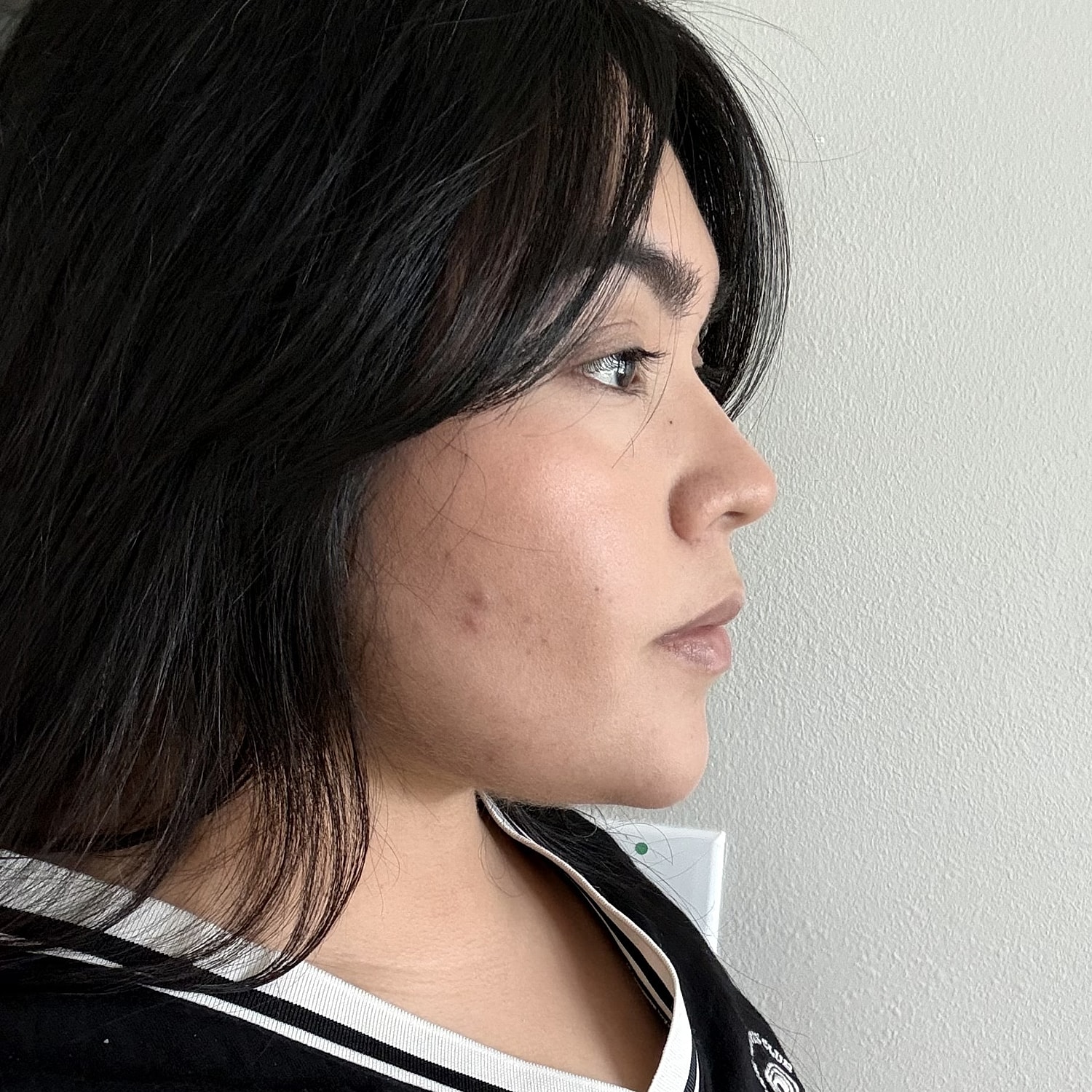 Profile view of a woman with dark hair.