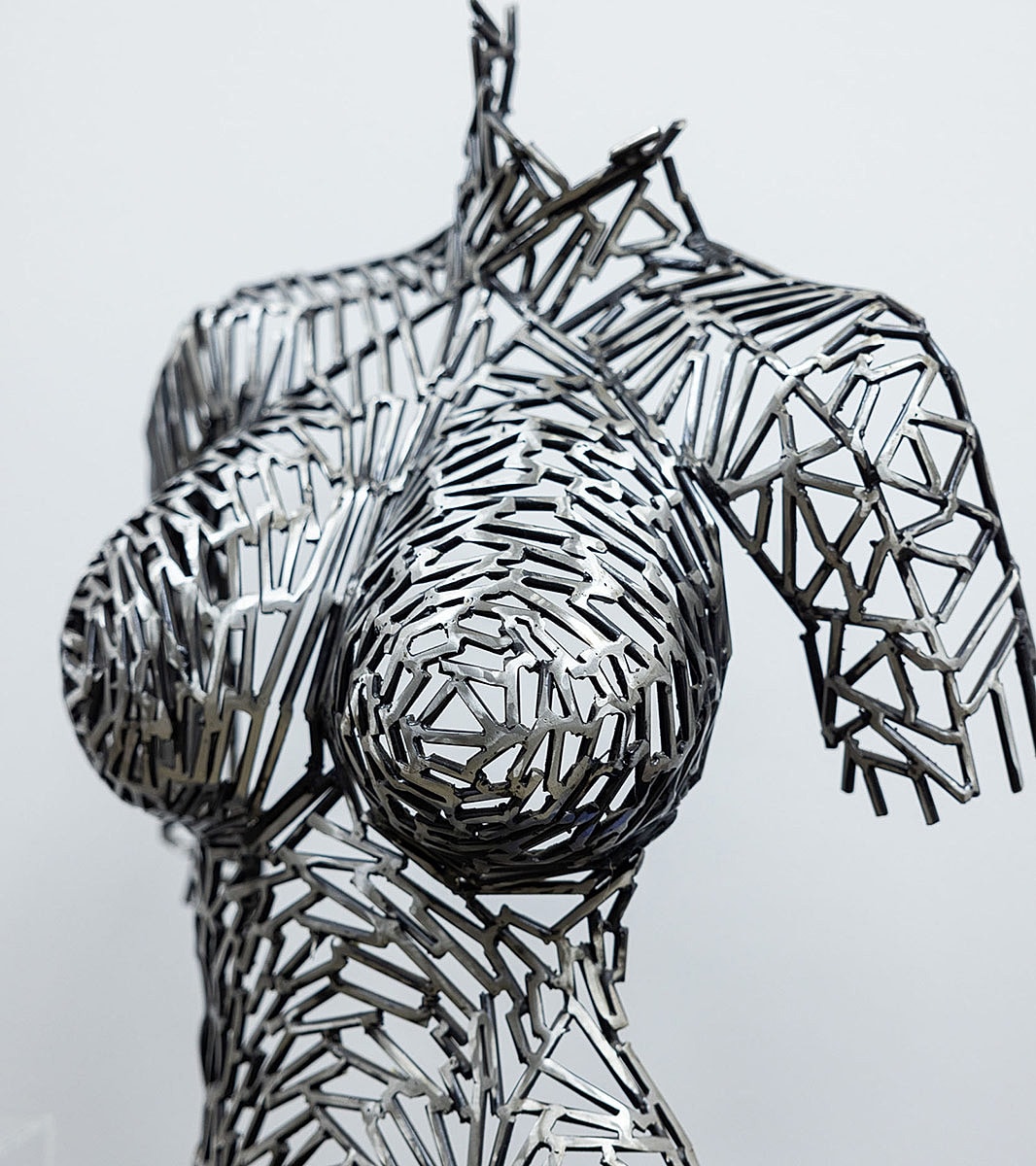 Abstract metal sculpture of the human torso.