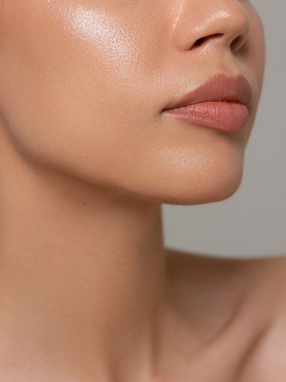 Close-up of lips and smooth skin texture.