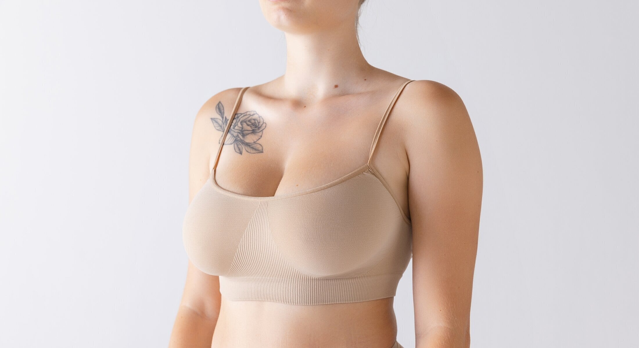 Model wearing a neutral-colored bra top.