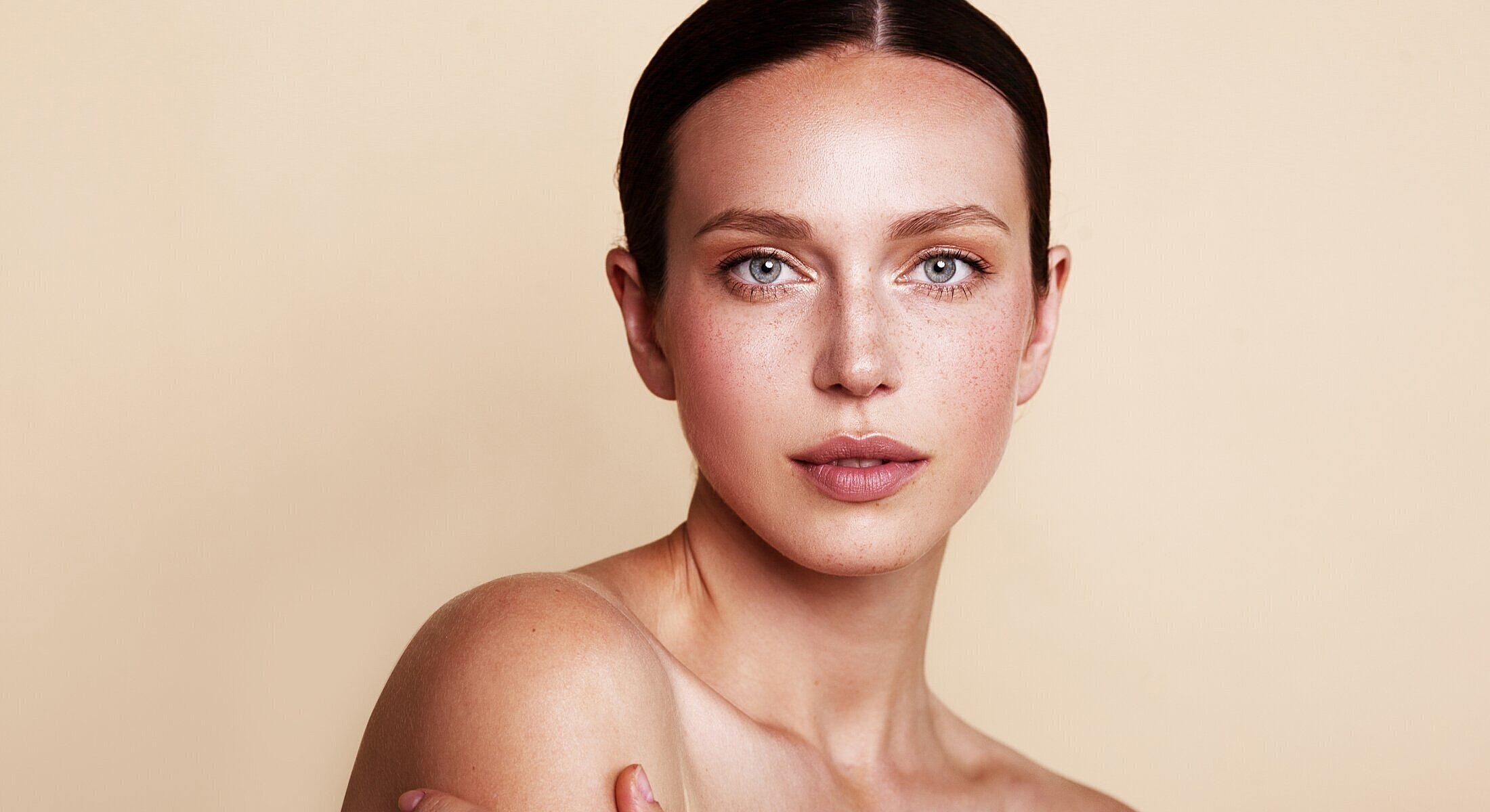 Beauty portrait of a woman with freckled skin.
