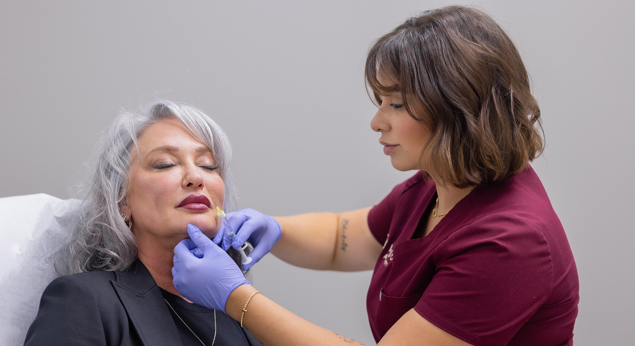 Cosmetic treatment session in a clinical setting.