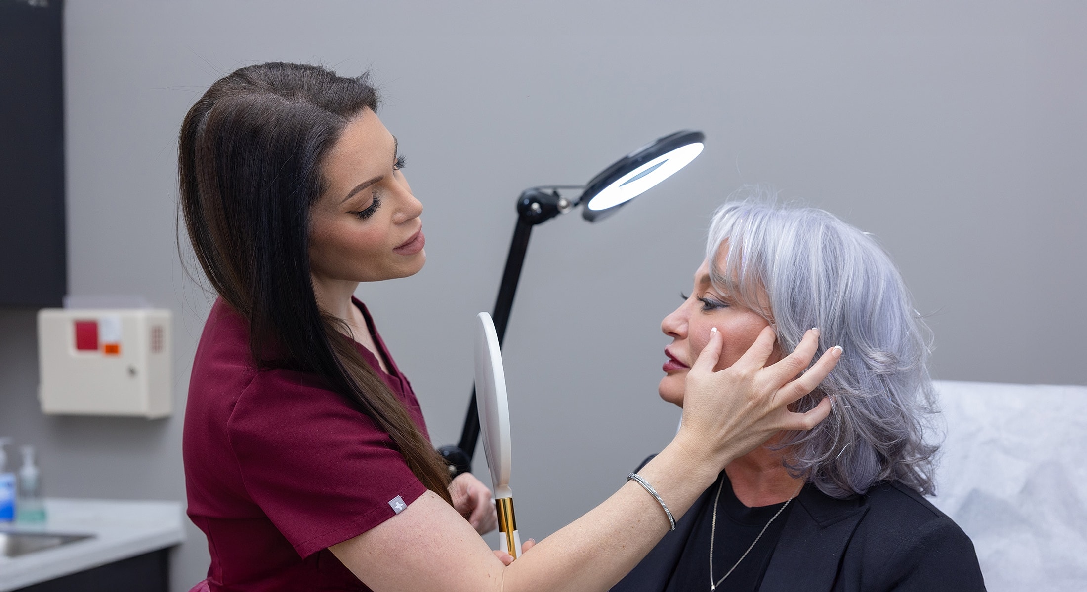Cosmetic consultation between a practitioner and client.
