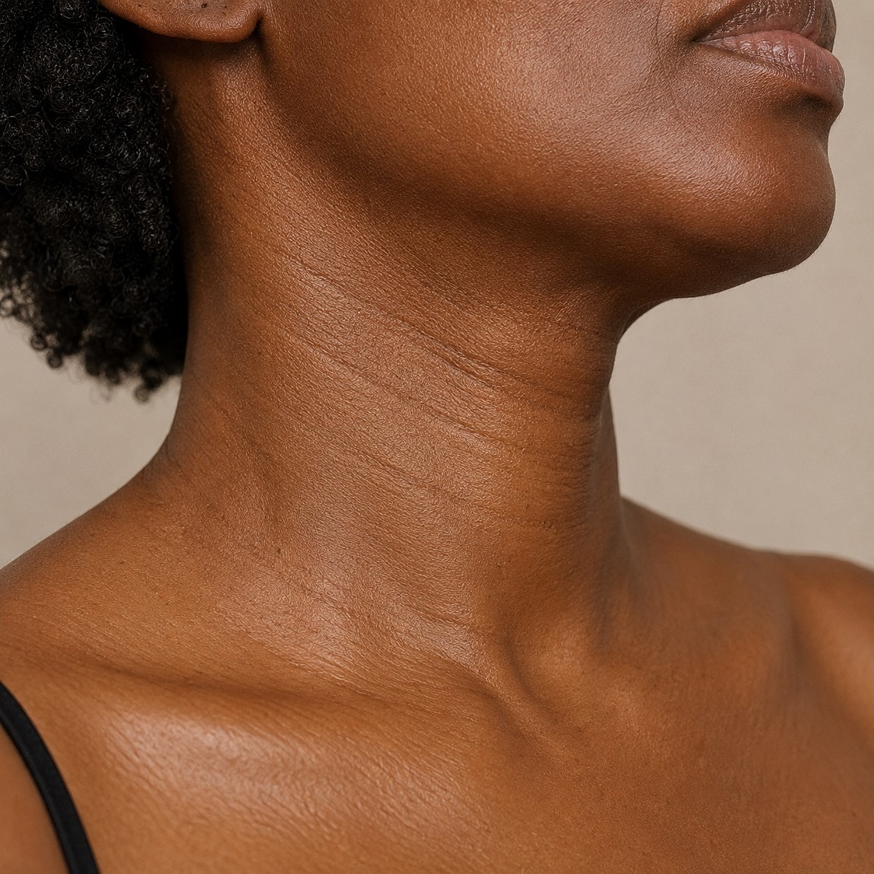 Close-up of a woman's neck and shoulder.