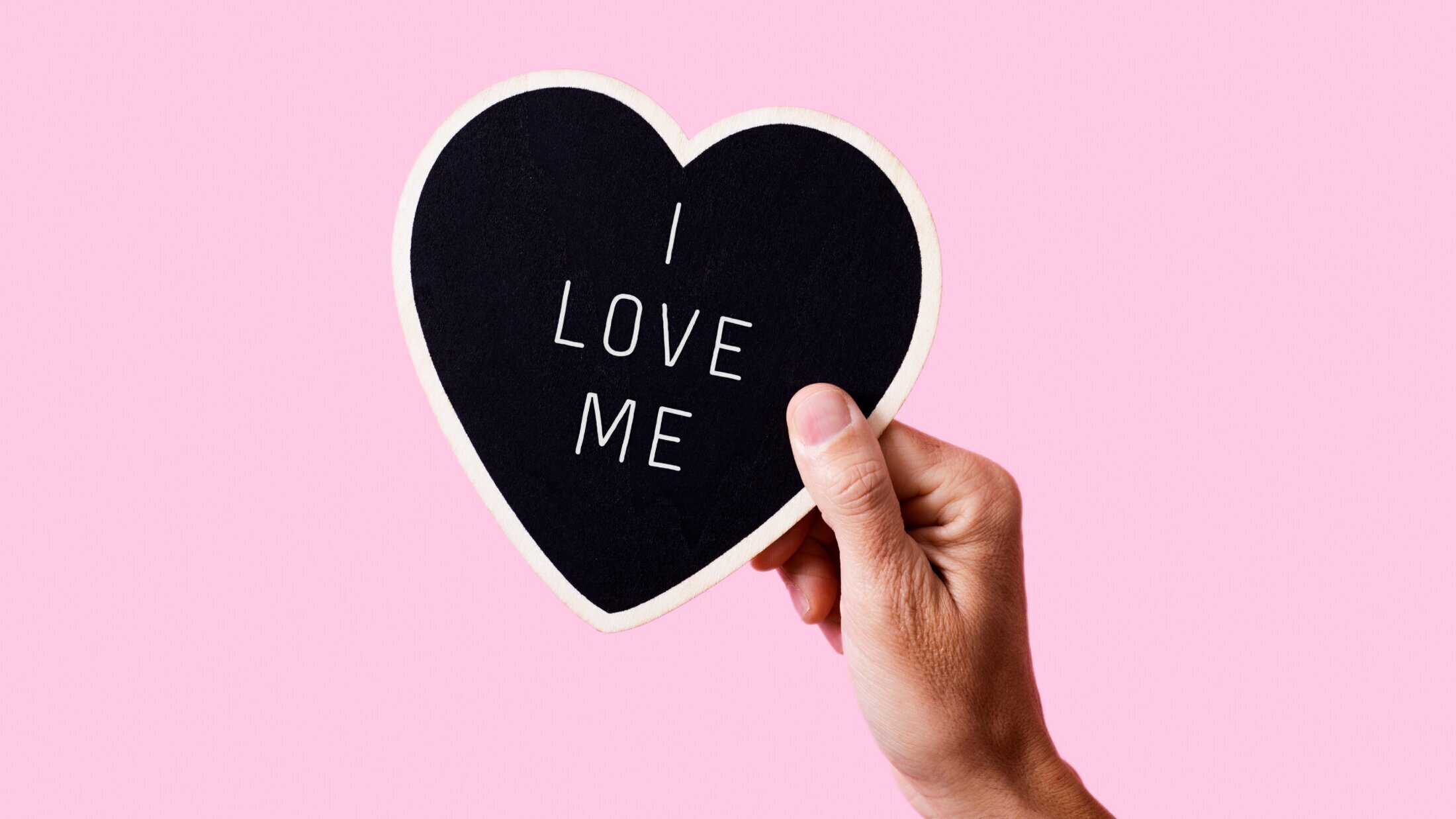 plastic surgery patient model holding a cut out card with i love me written on it